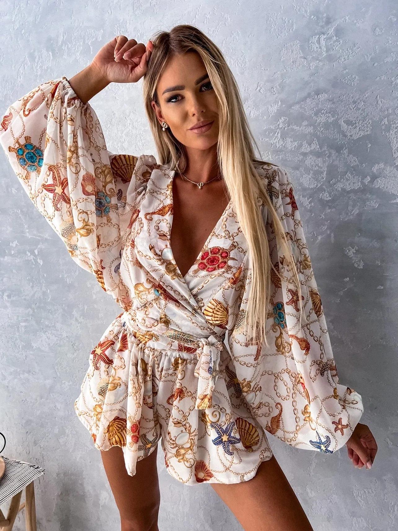 Bohemian V-Neck Wrap Jumpsuit with Flowing Sleeves and Tropical Elegance