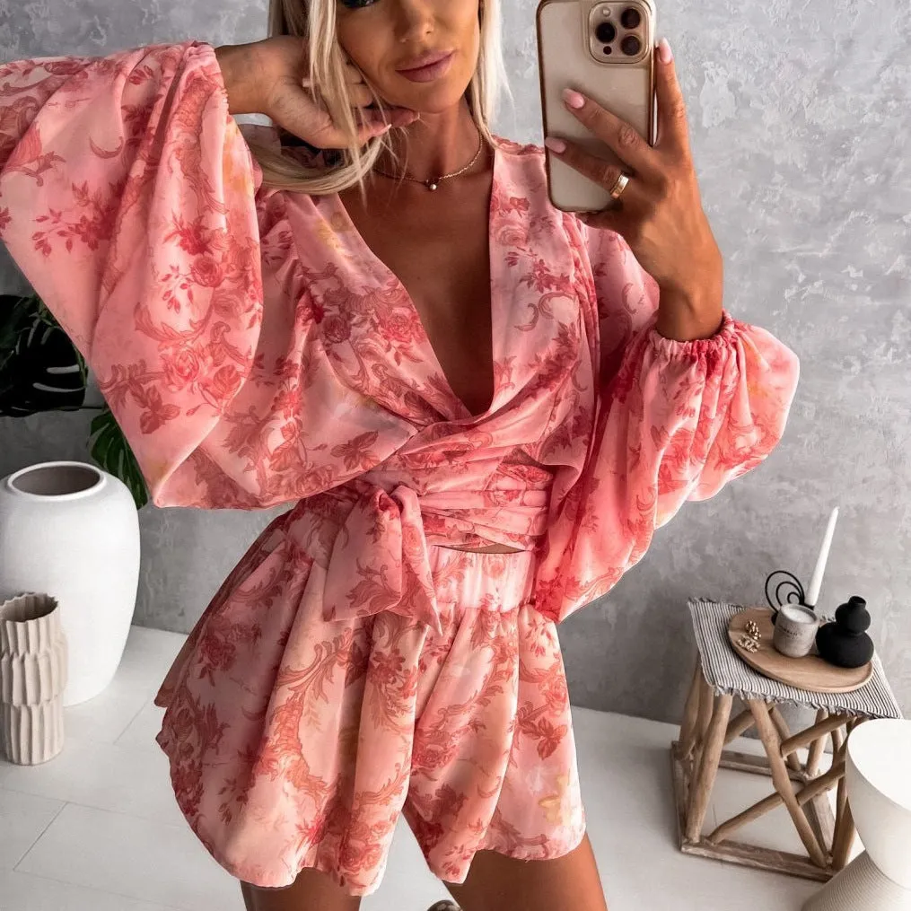 Bohemian V-Neck Wrap Jumpsuit with Flowing Sleeves and Tropical Elegance